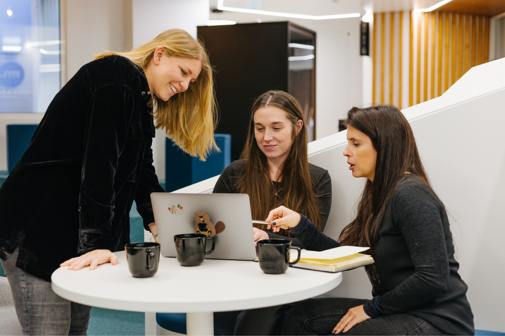 Marketers collaborating over laptop