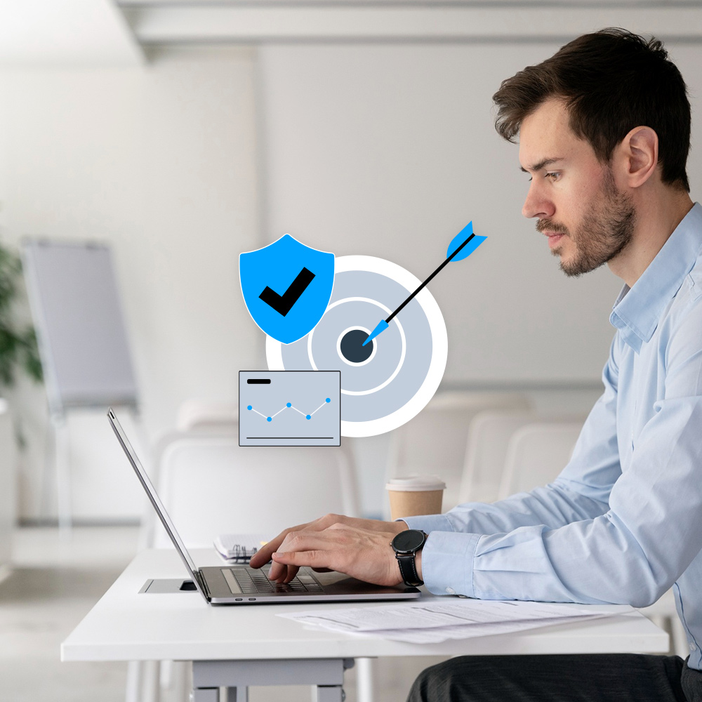 Imagen de un hombre frente a un ordenador y un icono de diana y escudo