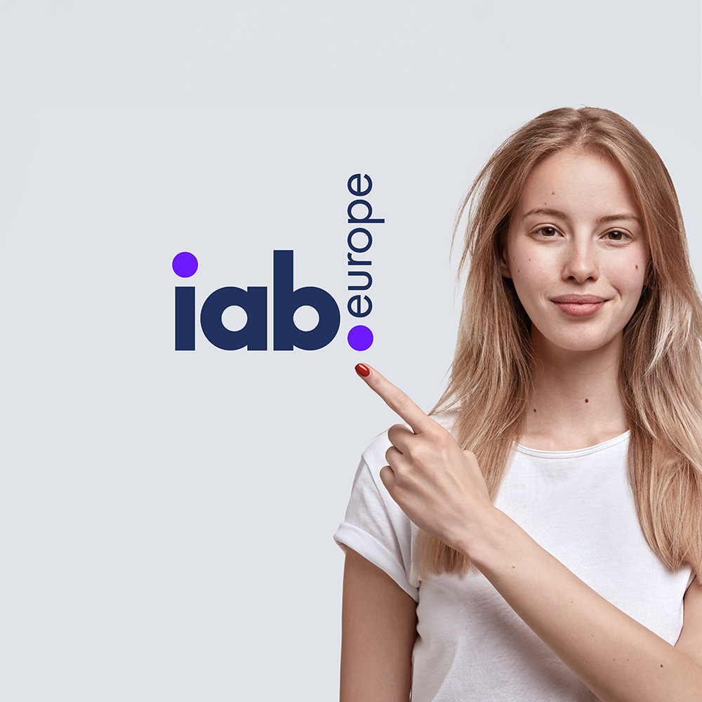 IAB Europe logo with lady pointing at it