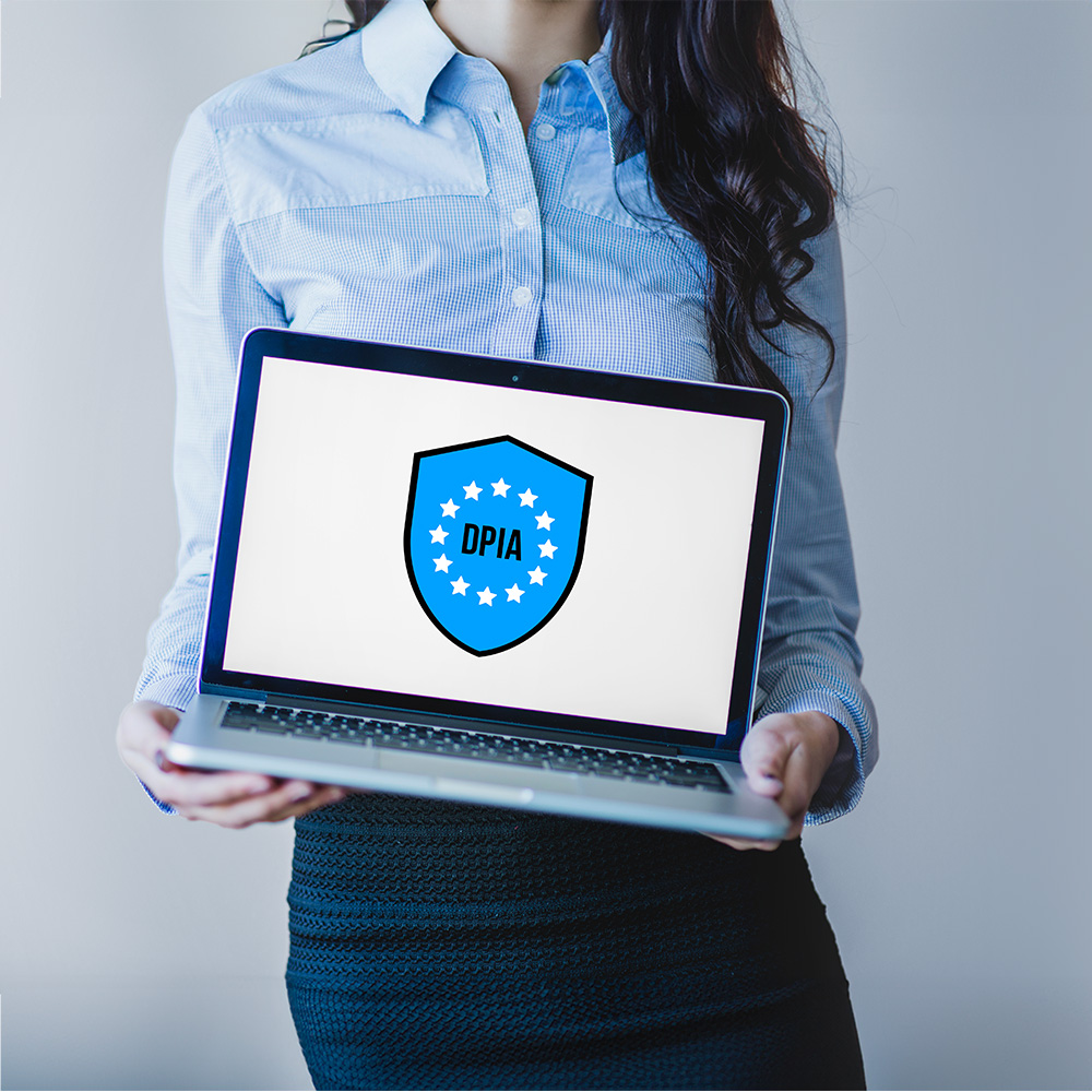 Woman holding laptop with DPIA shield