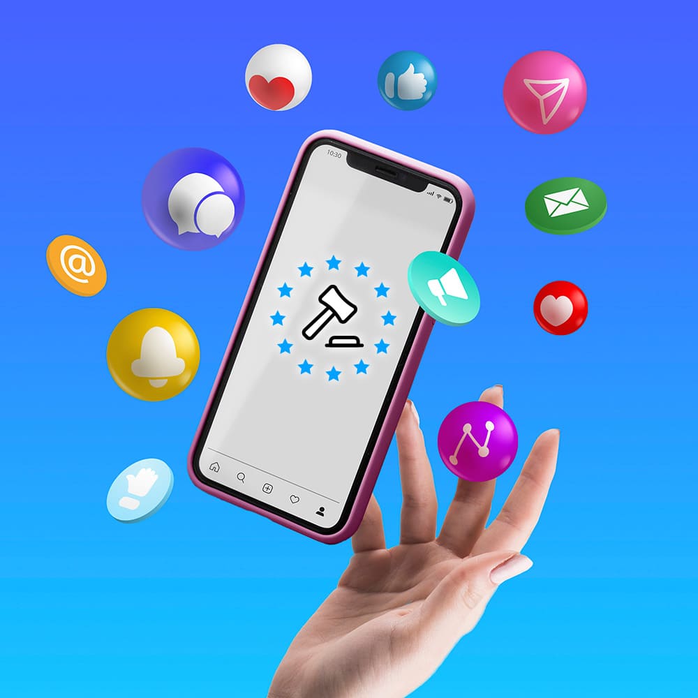 Hand holding a phone surrounded by icons related to social media