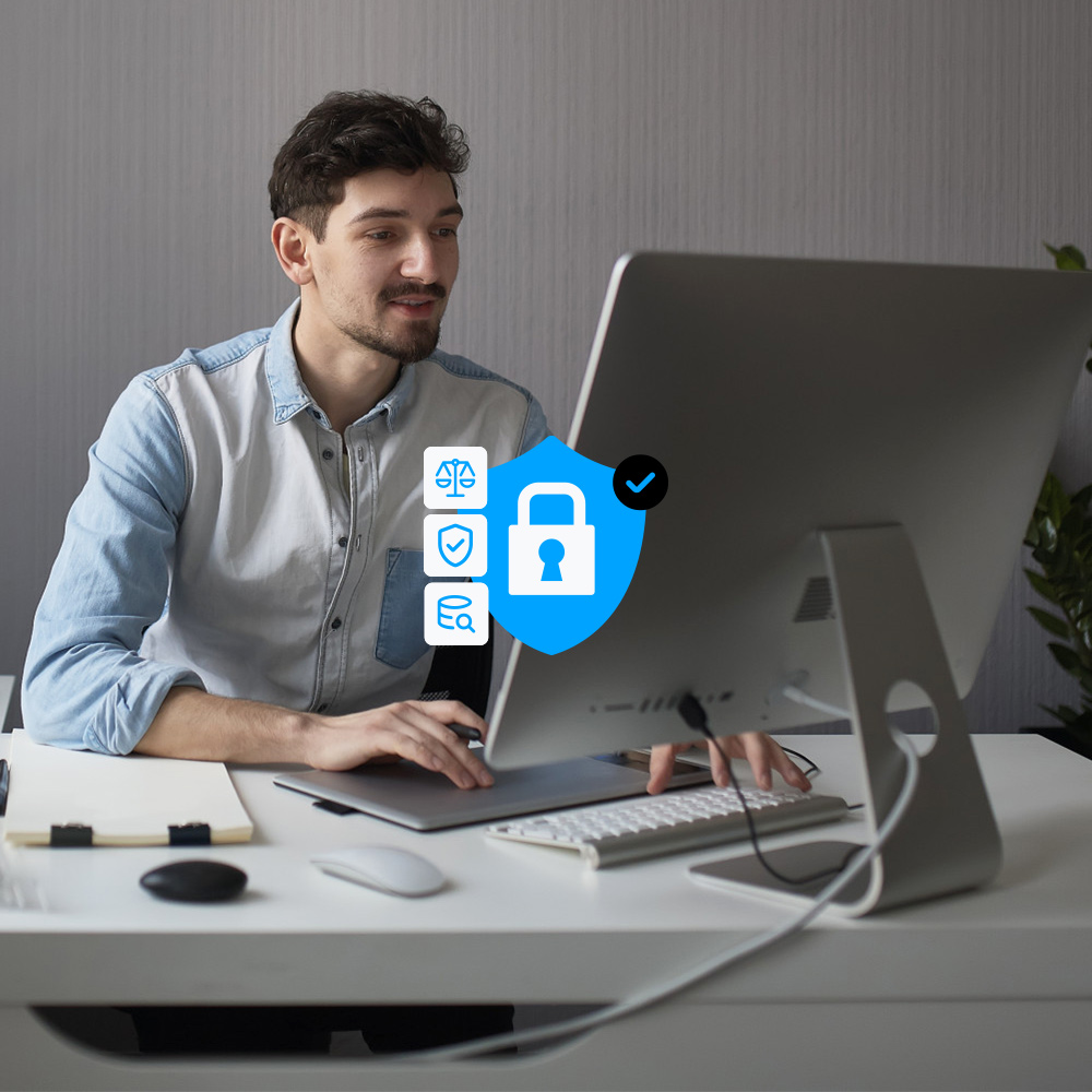Image of a man in front of a computer and some privacy icons on top